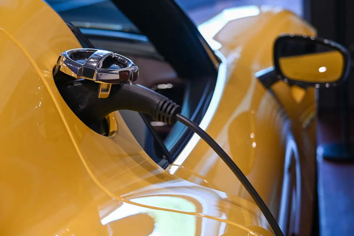 Câble de recharge branché sur une voiture électrique, gros plan sur le connecteur